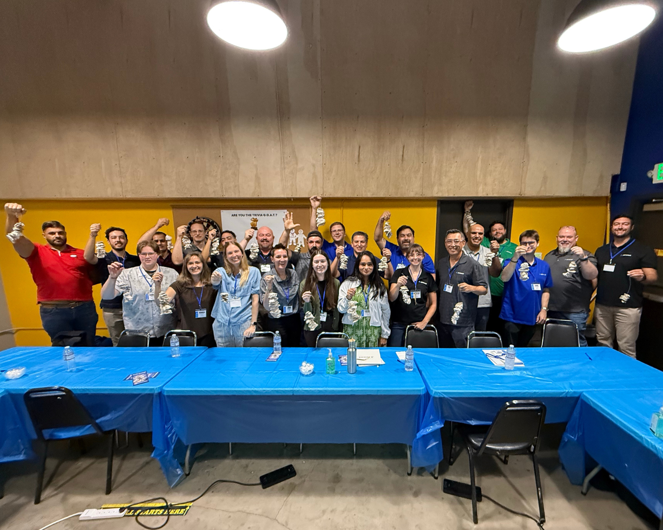 Group photo of Advance employees, each holding a string of oyster shells.