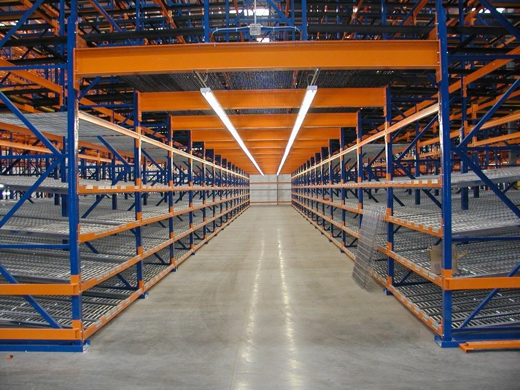 Empty warehouse with metal shelving racks and bright overhead lighting.