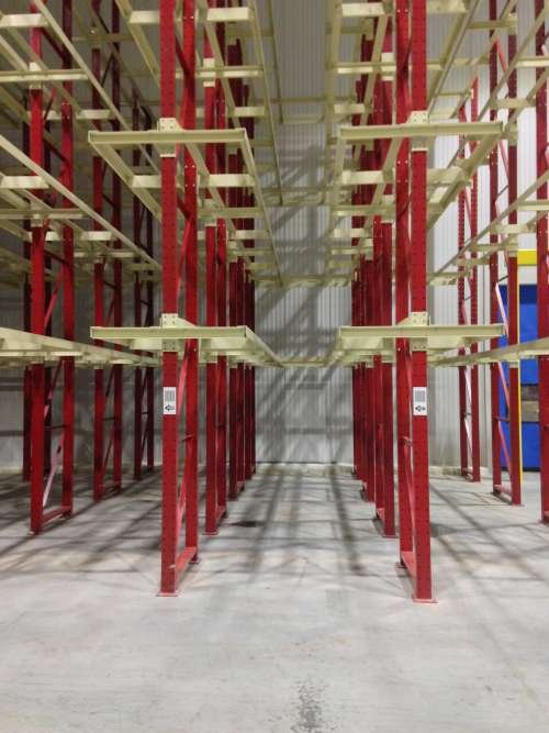 Empty two-wide warehouse racking units.