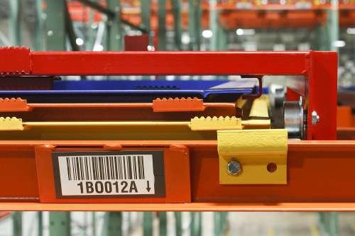 Close-up of a warehouse pushback racking layered carts.