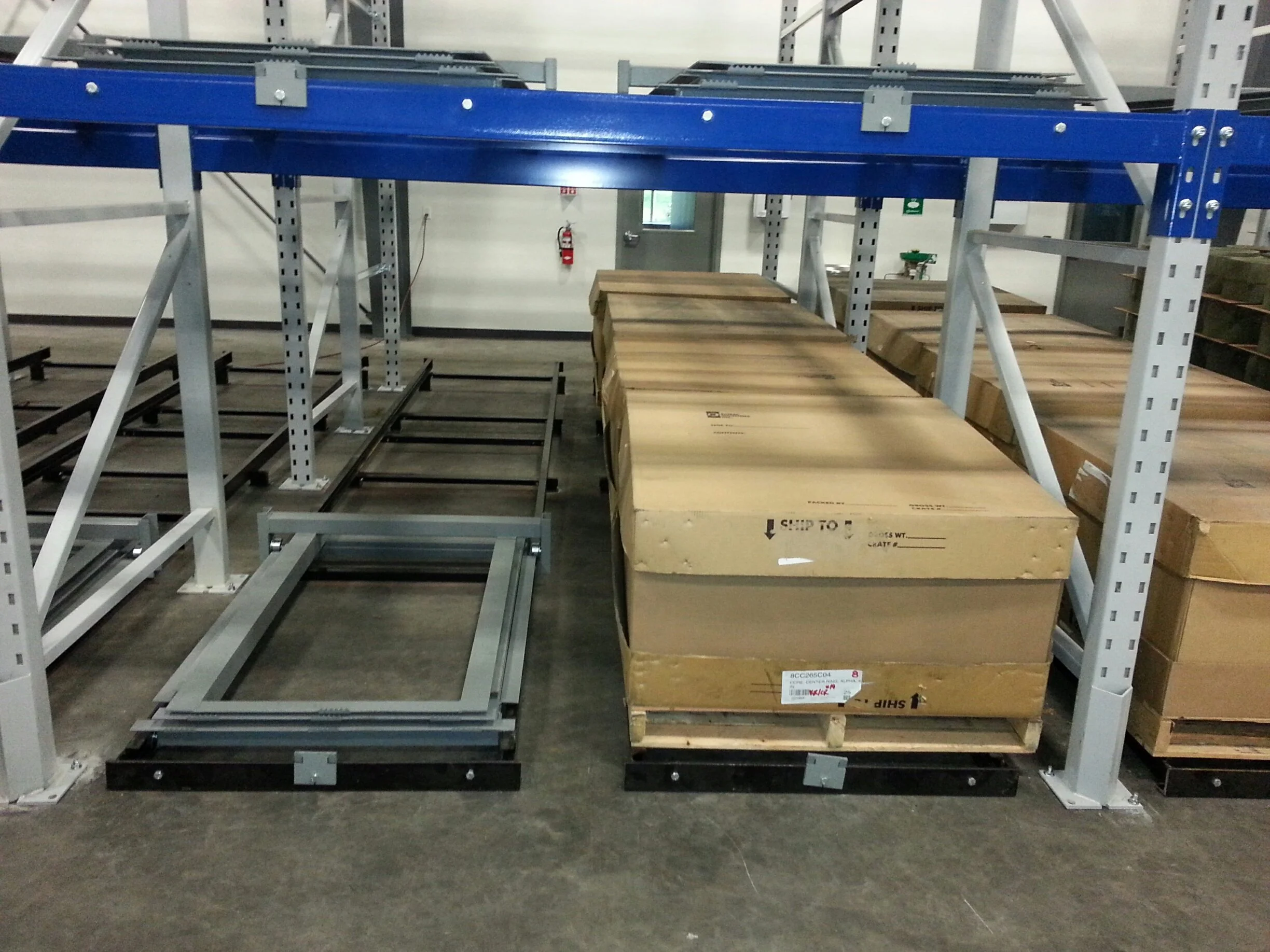 Pushback racks with large cardboard boxes.