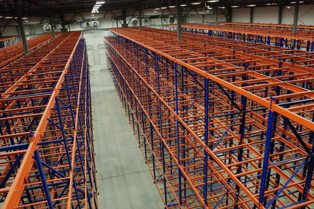 Empty industrial warehouse with very high bay storage racks.
