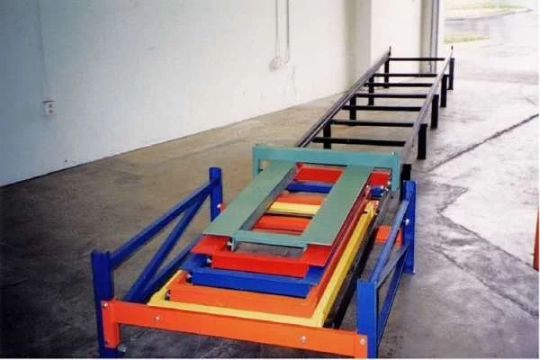 Colorful stacked metal pushback carts.