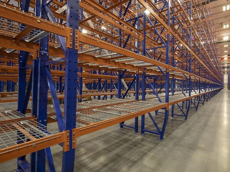 Empty warehouse storage racks with wire bottoms shelving in rack.