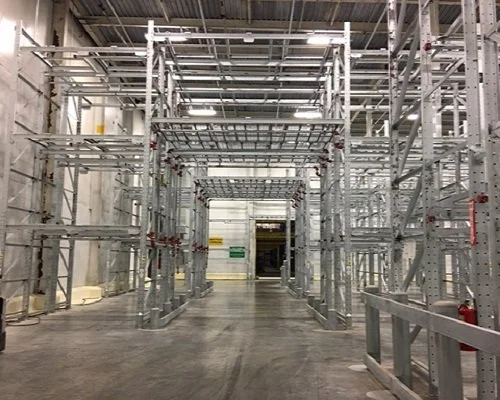 Warehouse pick tunnel through metal storage racking.