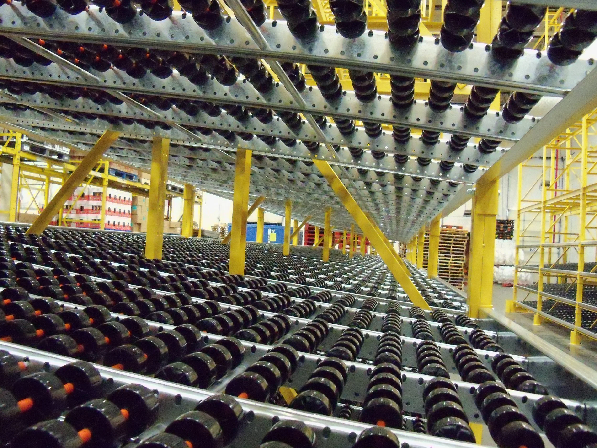 Rows of skate wheel rollers in a carton flow system.