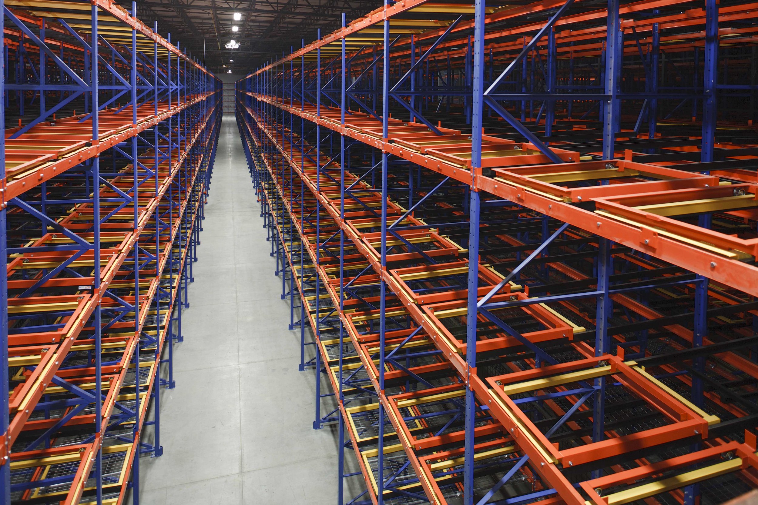 Empty warehouse storage shelves with pushback racks.