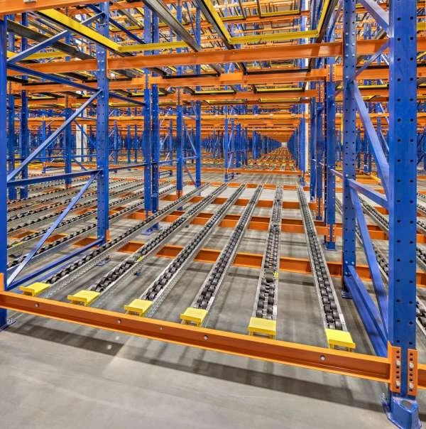 Multiple levels of orange and blue pallet flow racking.