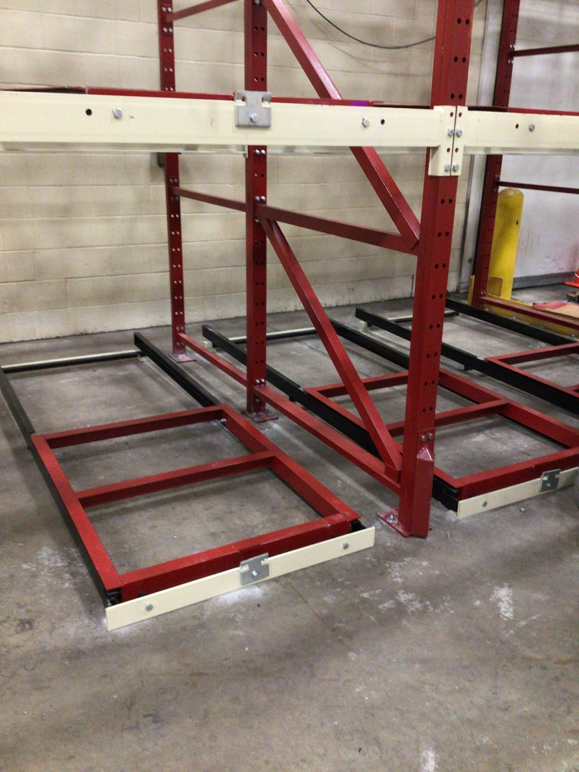 A floor mounted pushback storage rack system.