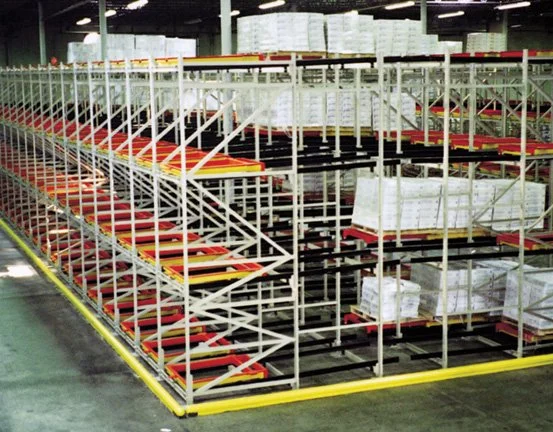 Drive-In Retrofit Pushback storage racking with stacked boxes and pallets.