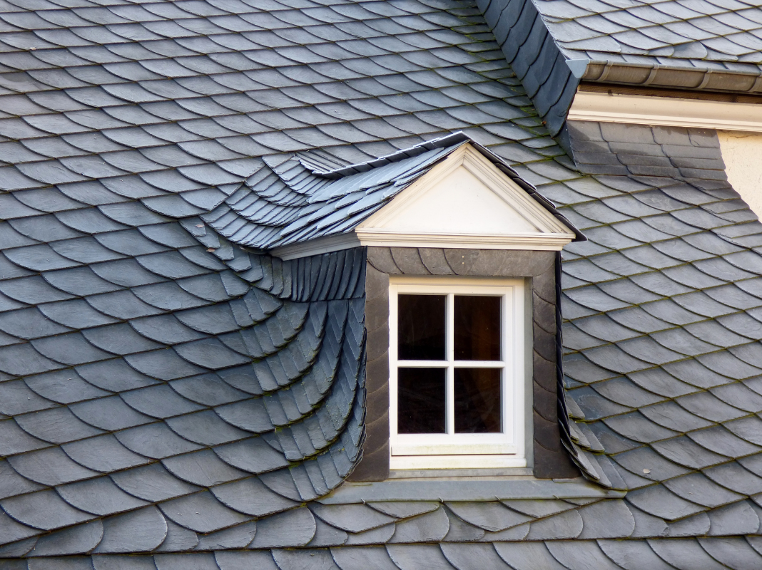 Close-up of a dormer window on a slate roof.