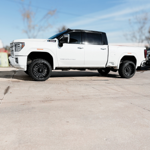 GMC Denali with black wrap, Axe Kratos wheels, and Fury MT2 tires installed by Pence Motorsports