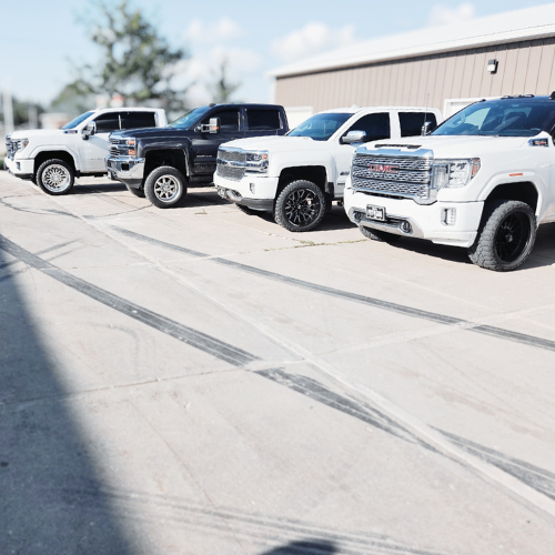 Chevy and GMC trucks with custom wheel upgrades installed by Pence Motorsports