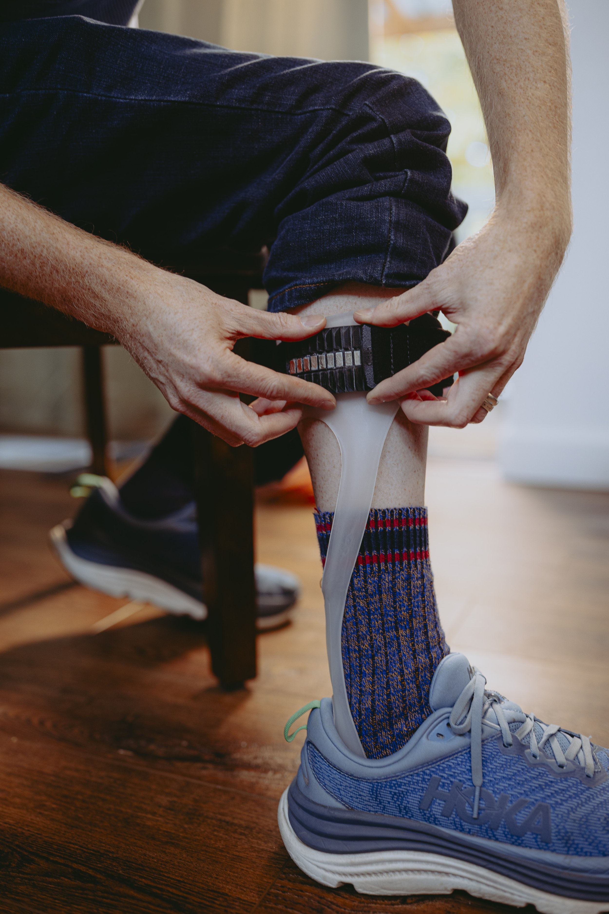 Person wearing orthotic brace with Cinch Ratchet R Series magnetic strap for easy alignment and comfortable use.