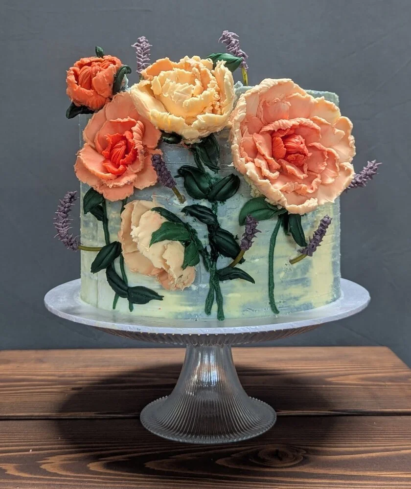 A single-tier luxury wedding cake decorated in peach coloured white chocolate peonies. 