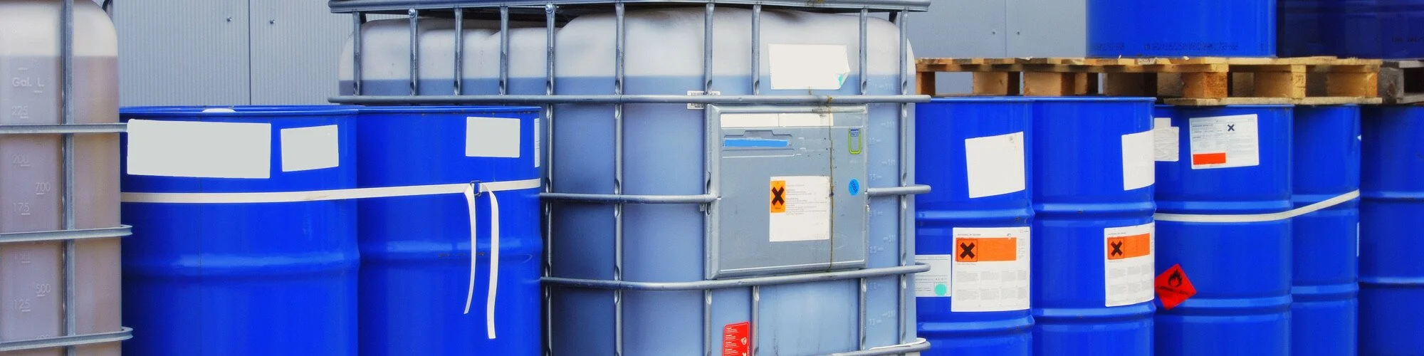 Blue drums filled with hazardous waste.