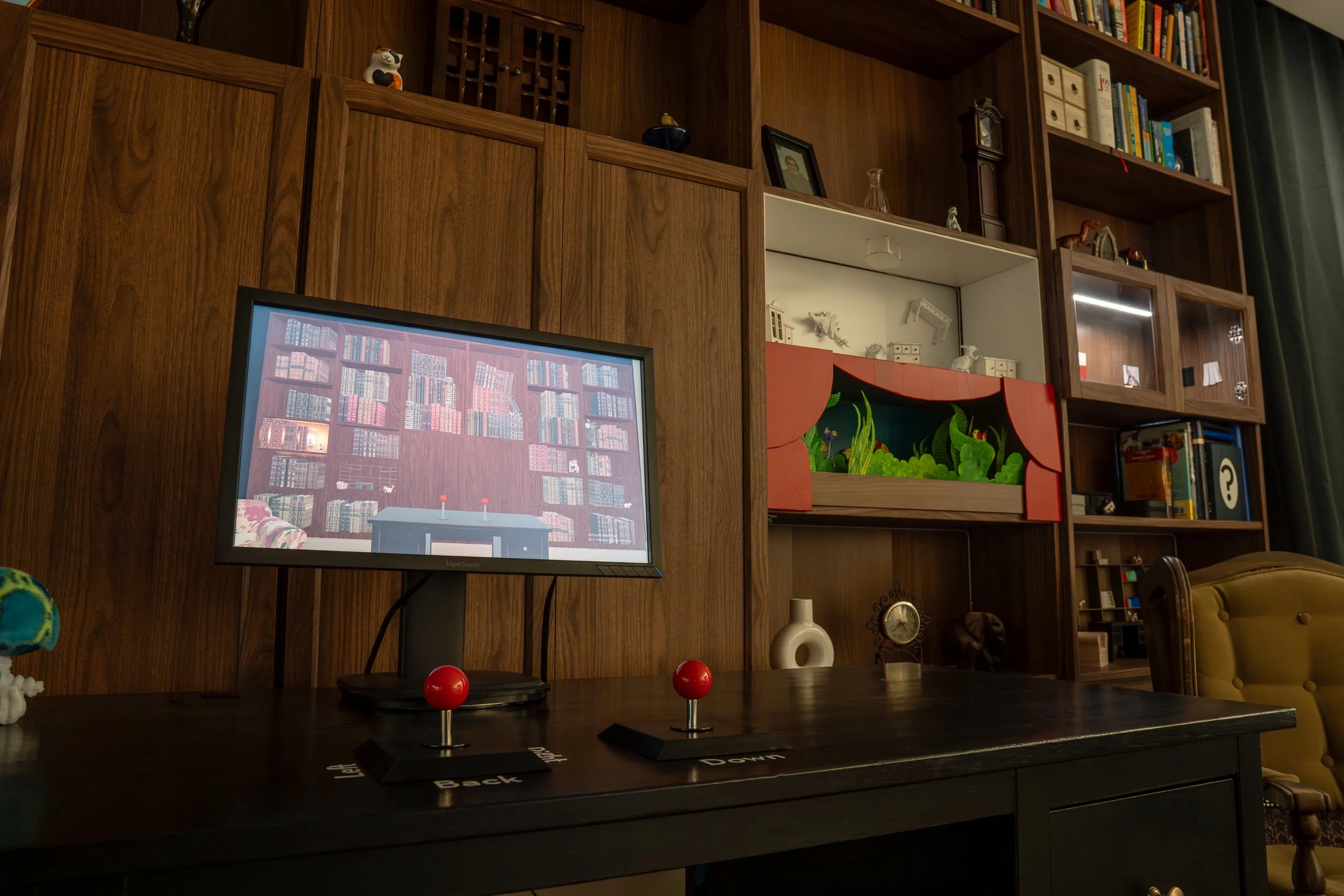 A computer game in front of a very full bookshelf