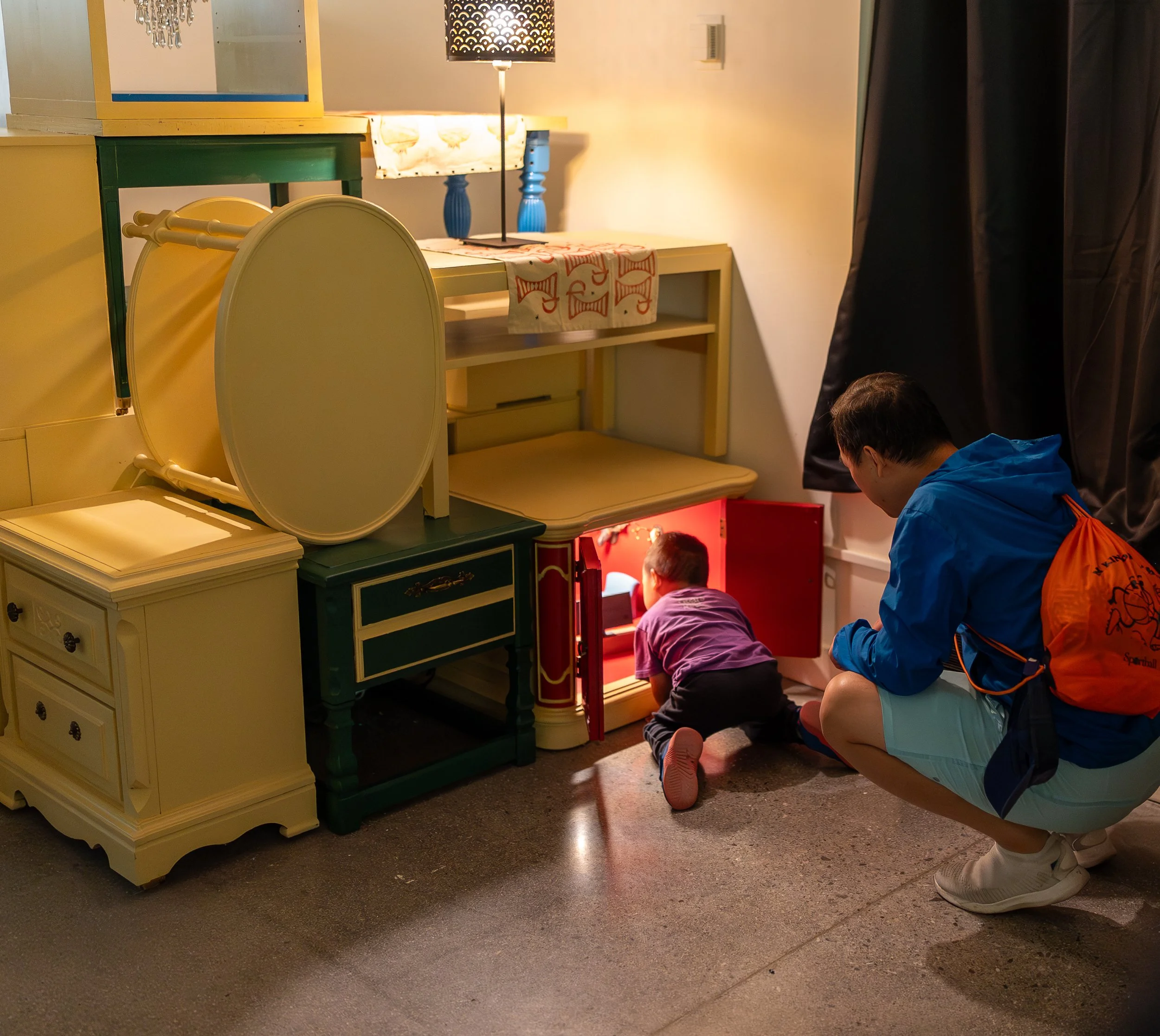 A small child investigates a hidden compartment