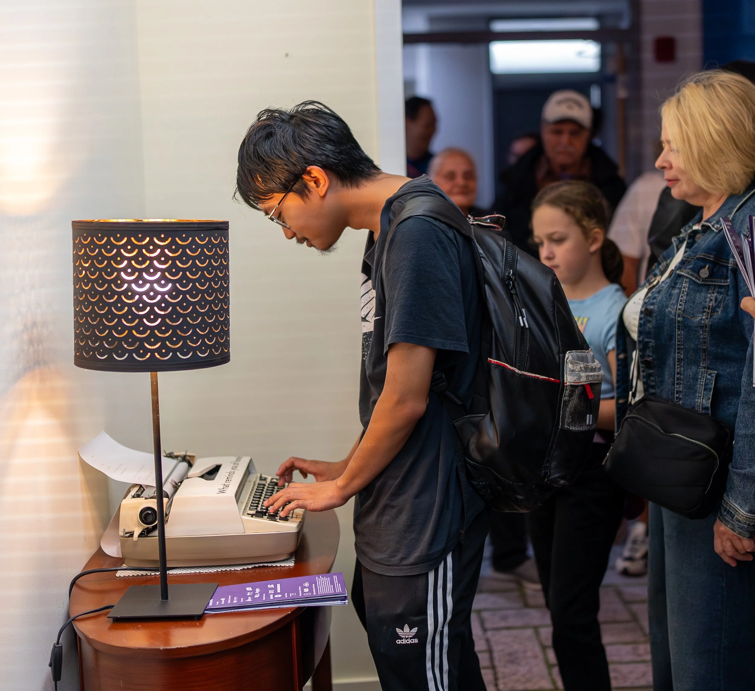 A young man typing at a typewriter