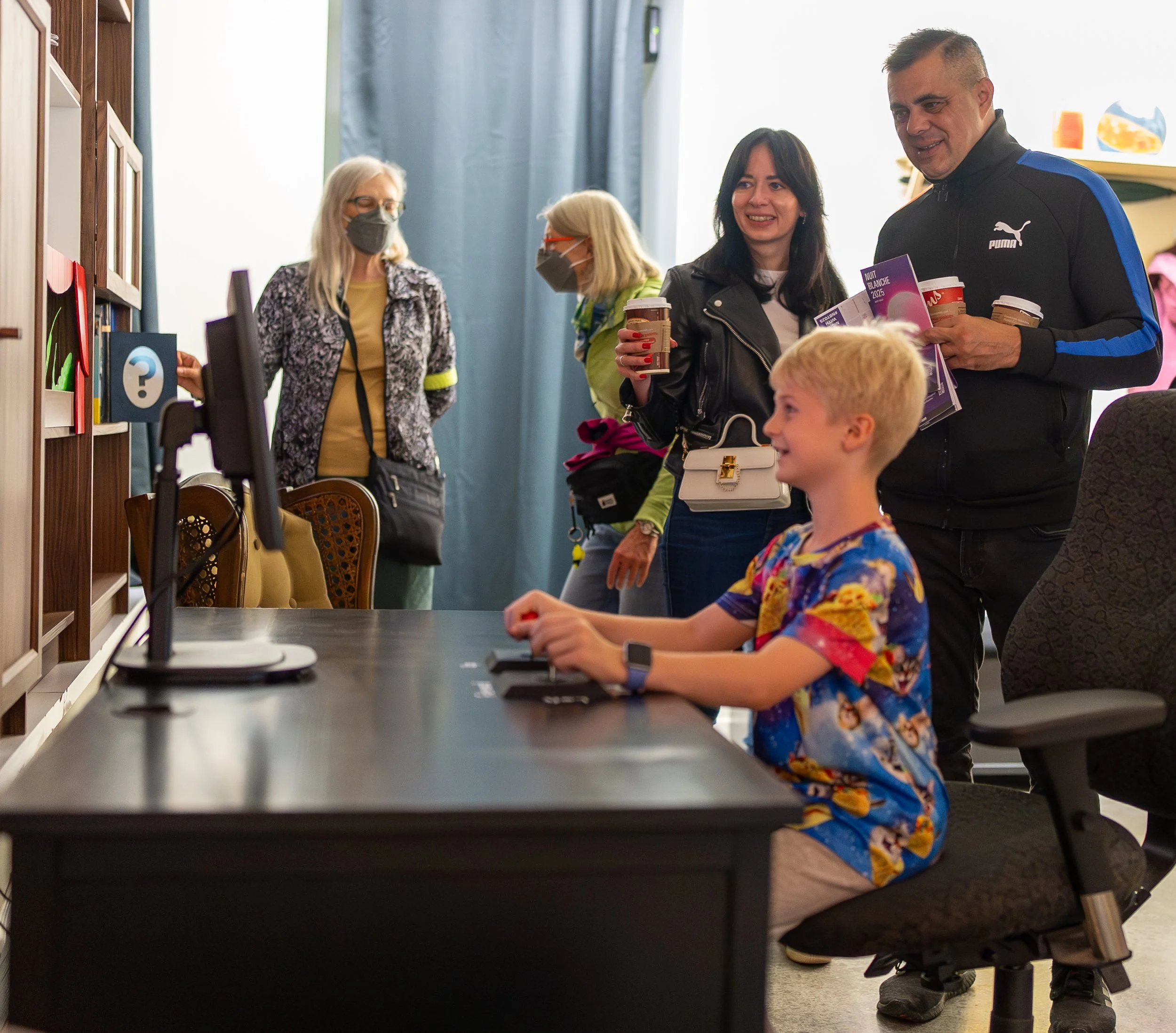 A boy playing a computer game and smiling