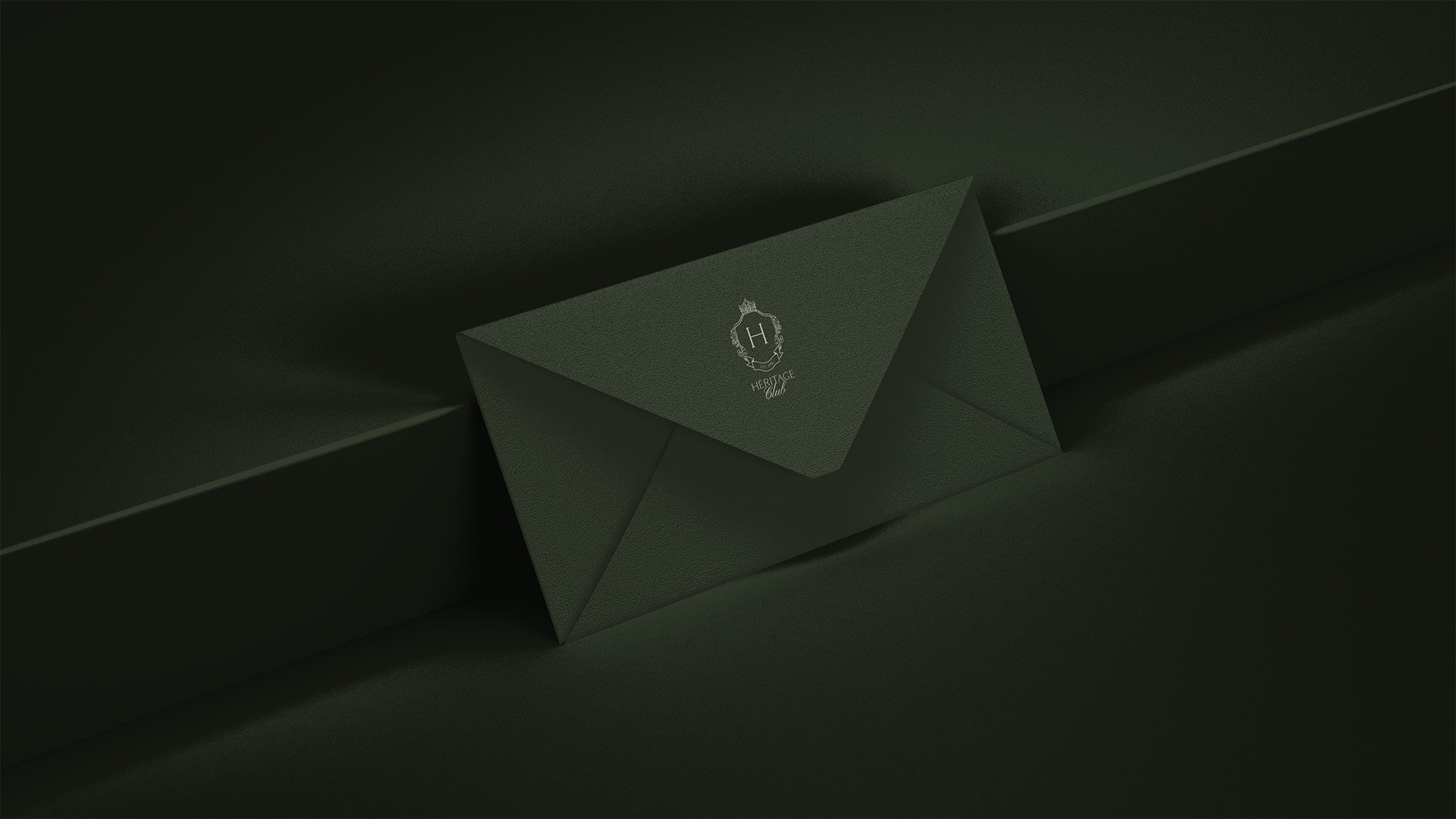 Heritage Club dark green envelope with gold embossed logo of Heritage H logo and the words Heritage Club