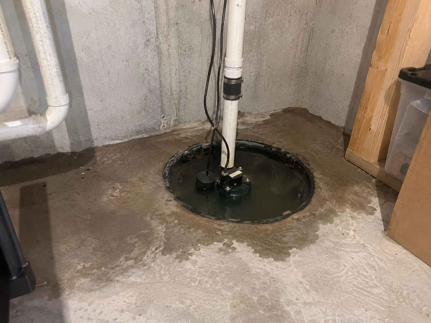 Sump pump pit overflowing in an Olathe, KS basement