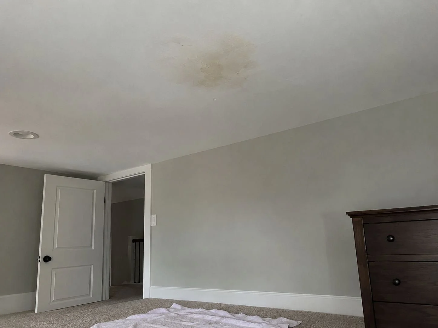 Ceiling water stain from a leaking attic pipe in a Lee's Summit, MO home