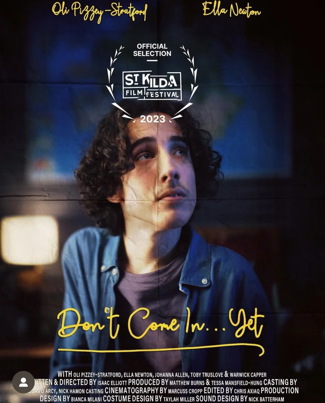 A poster for the film 'Don't Come In... Get' featuring a young man with dark curly hair, wearing a denim jacket, looking upwards. The poster shows that the film was an official selection at the 2023 St. Kilda Film Festival. The title is written in ye