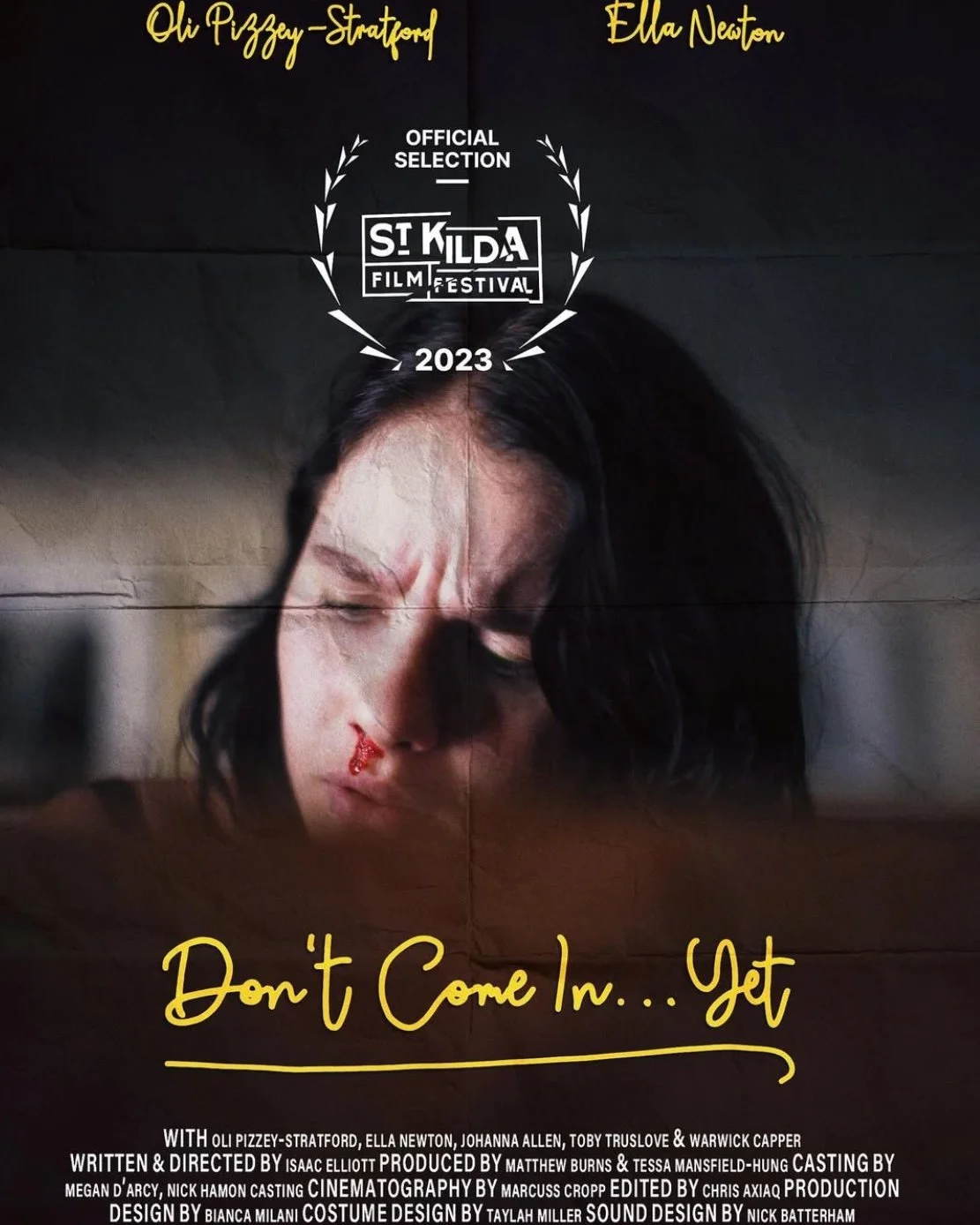 Poster for the film 'Don't Come In... Yet,' featuring a woman with a nosebleed and a pained expression. The poster includes text indicating the film's selection at the 2023 Saint Kilda Film Festival, with additional cast and crew information.