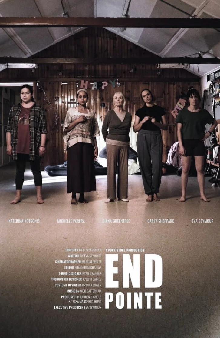 Five women standing in a row on a stage with a wooden backdrop, placeholder for a theater or film production. The women are facing forward with serious expressions. Text at the bottom lists production crew members and the title "END POINTE" in bold l