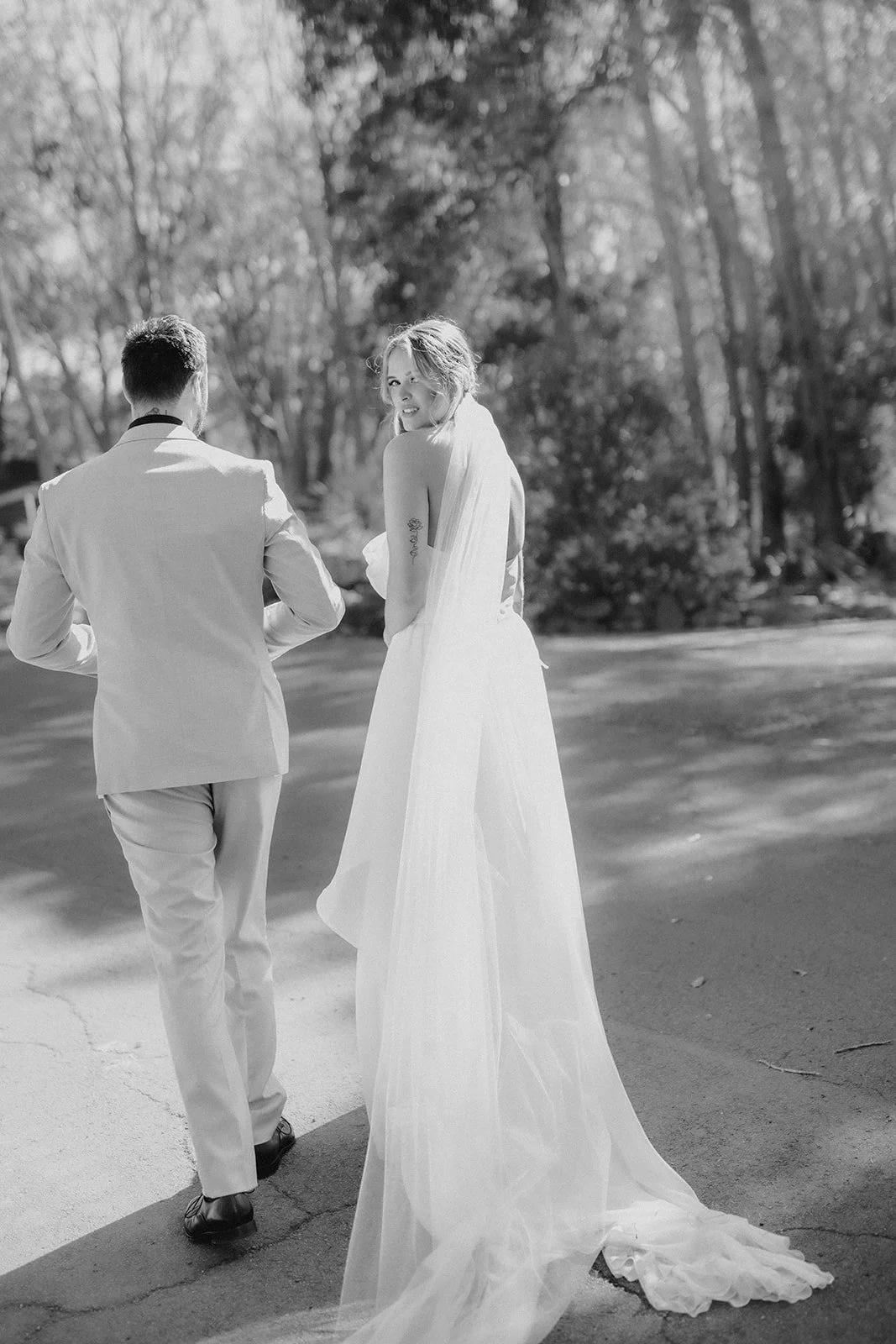 Bride and Groom on their elopement day at Bina Maya Retreat in Quedjinup W.A smiling at one another under the trees in perfect lighting.