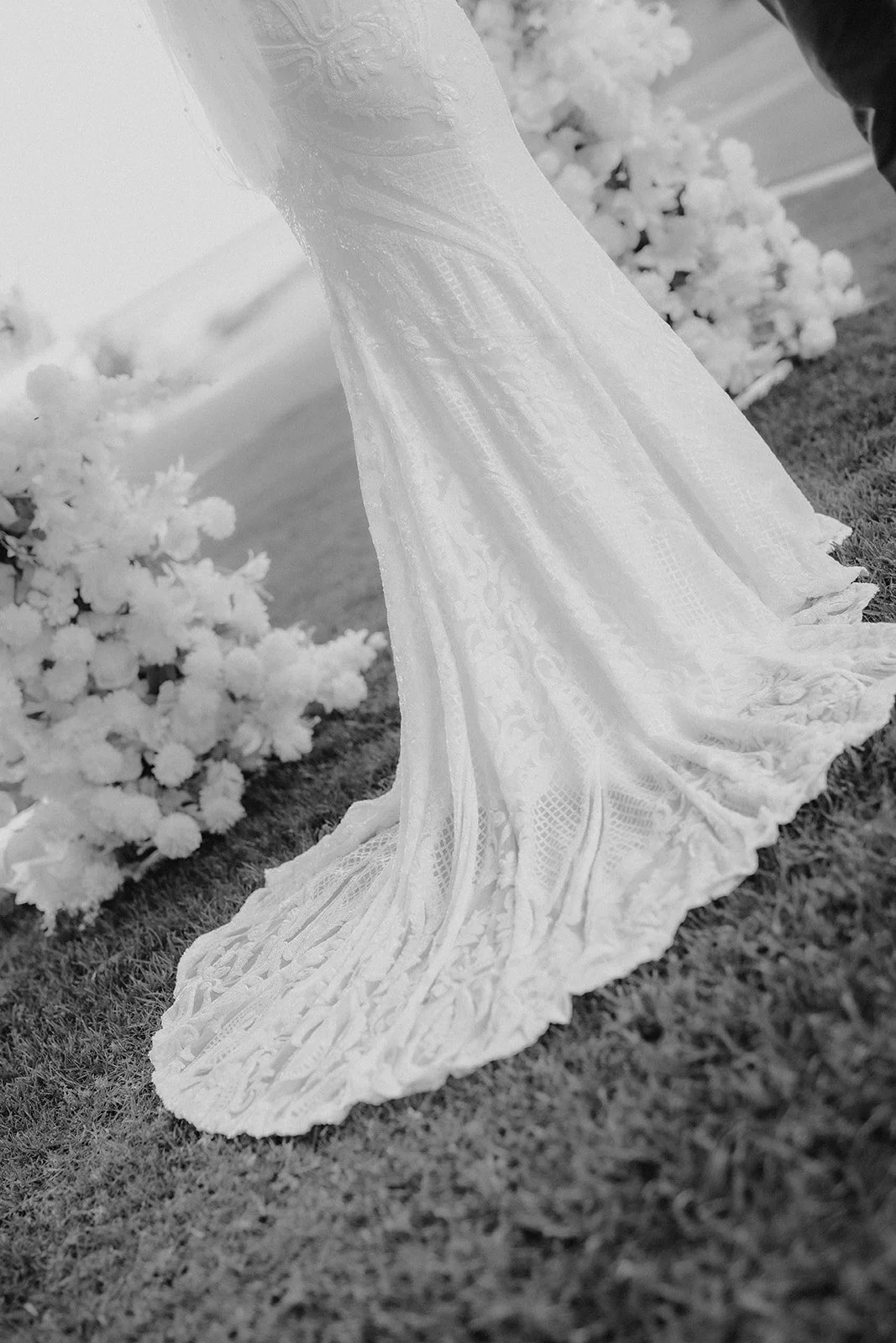 Bride with long dark hair standing in front of a wedding flower arbour at Whalers Cove in DUNSBOROUGH W.A at her elopement 