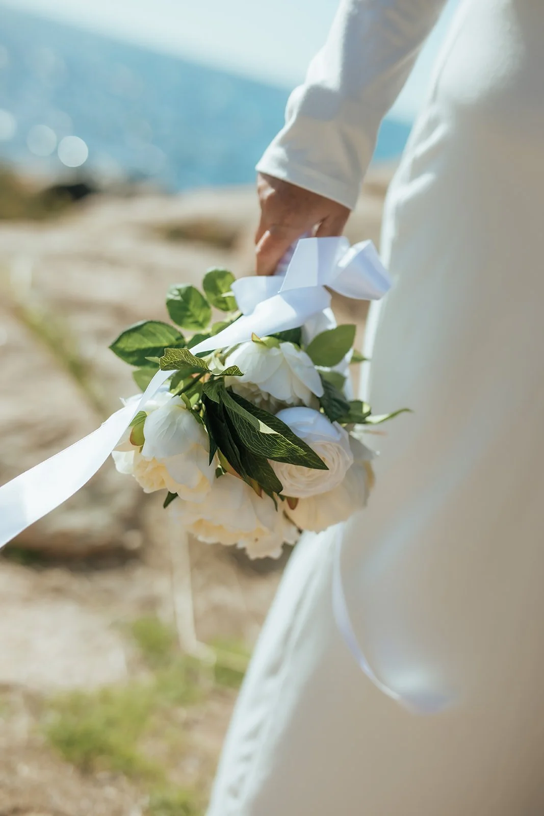 Bride holding her Bridal bouquet with white roses and white ribbon at Shelley Cove W.A on her elopement day