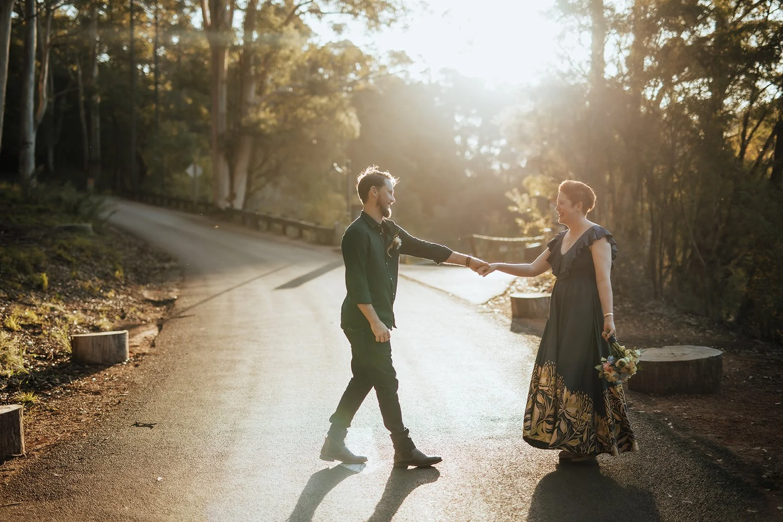 Bride and Groom at Karri Valley Resort in W.A dancing on the road in lovely light after they eloped