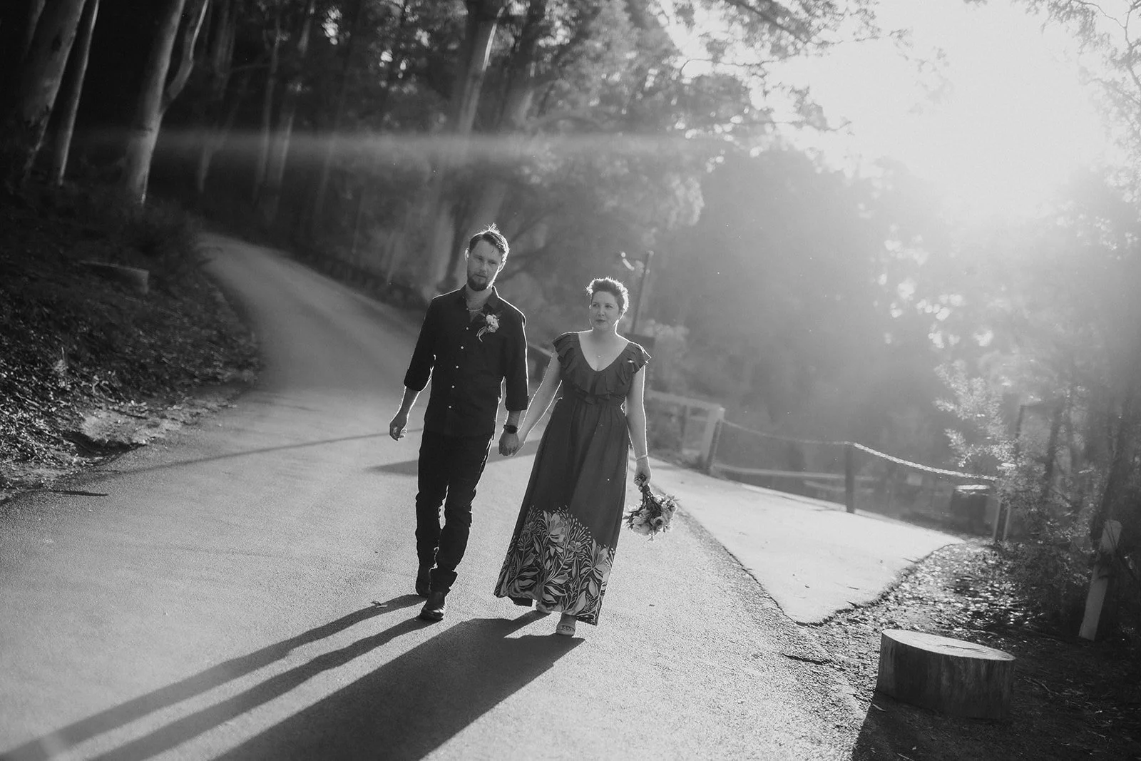 Bride and Groom at Karri Valley Resort walking down the road in lovely light after they eloped