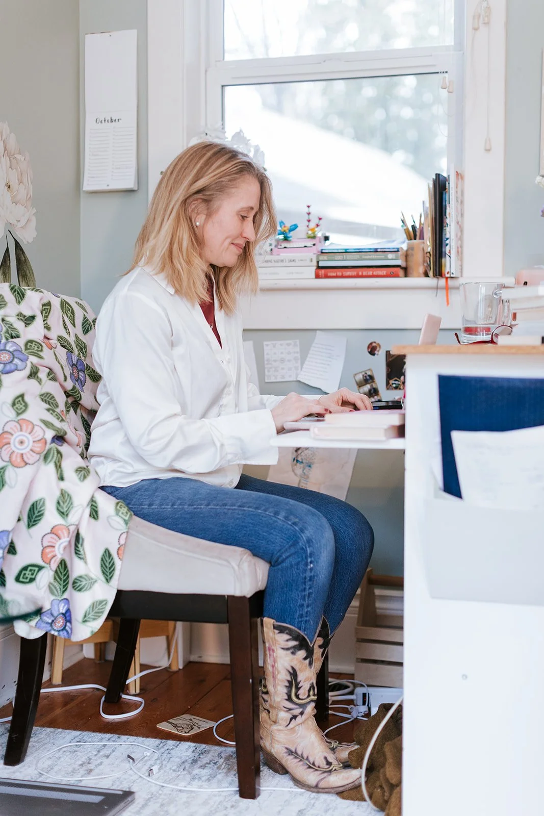 Alice Kuipers author sitting at her desk looking at laptop