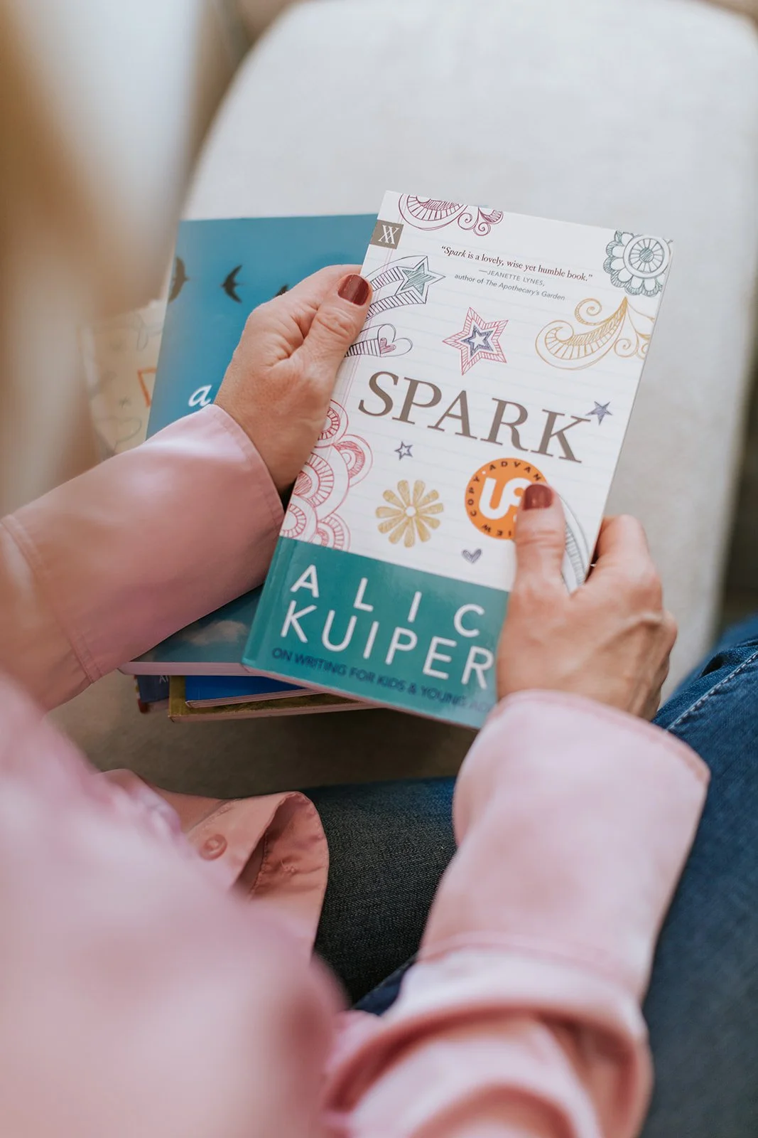 Alice Kuipers Author holding her book Spark