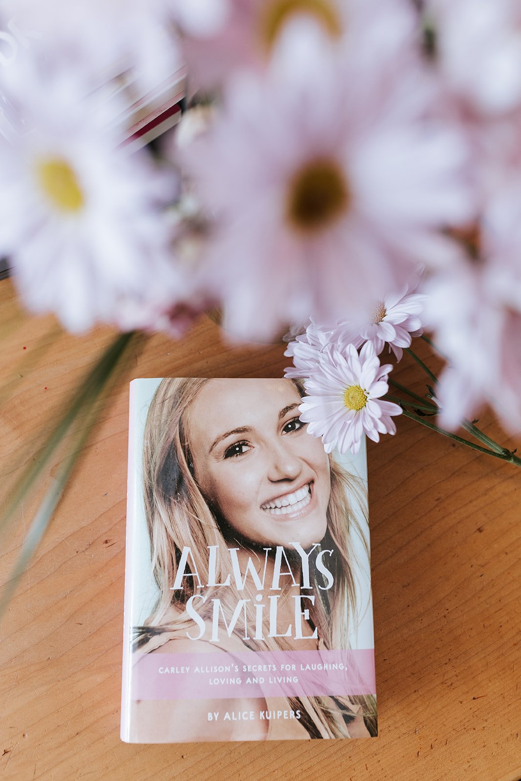 Alice Kuipers author Always Smile book beside flowers