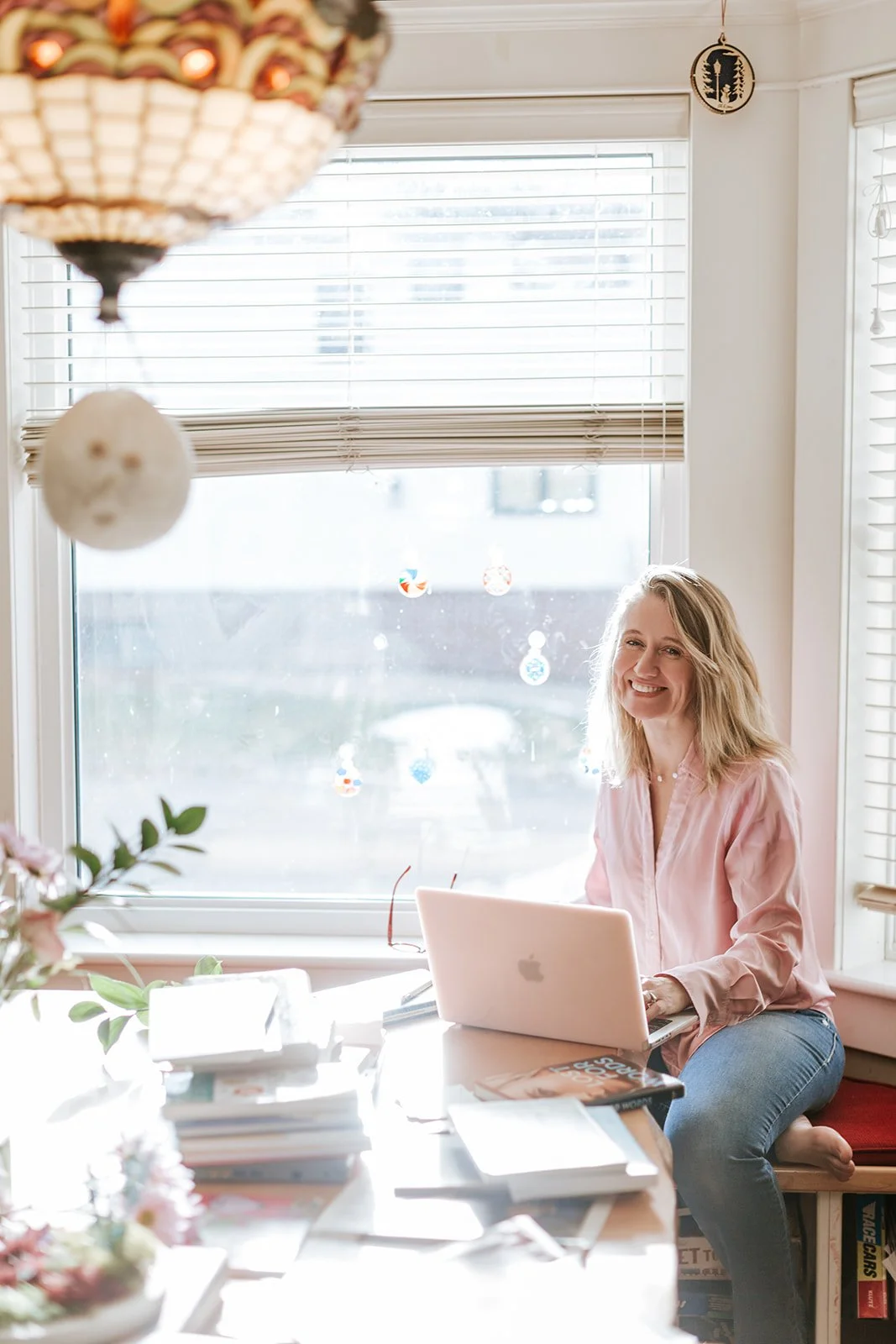 Alice Kuipers Author sitting in front of laptop smiling
