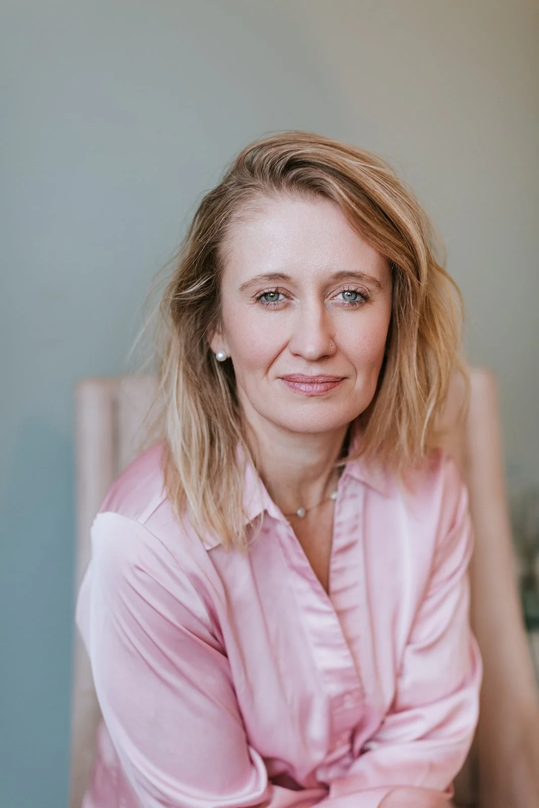 Alice Kuipers sitting on chair headshot