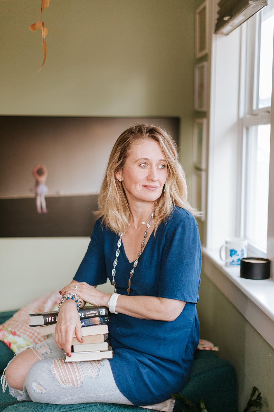 Alice Kuipers sitting smiling while looking off to the side