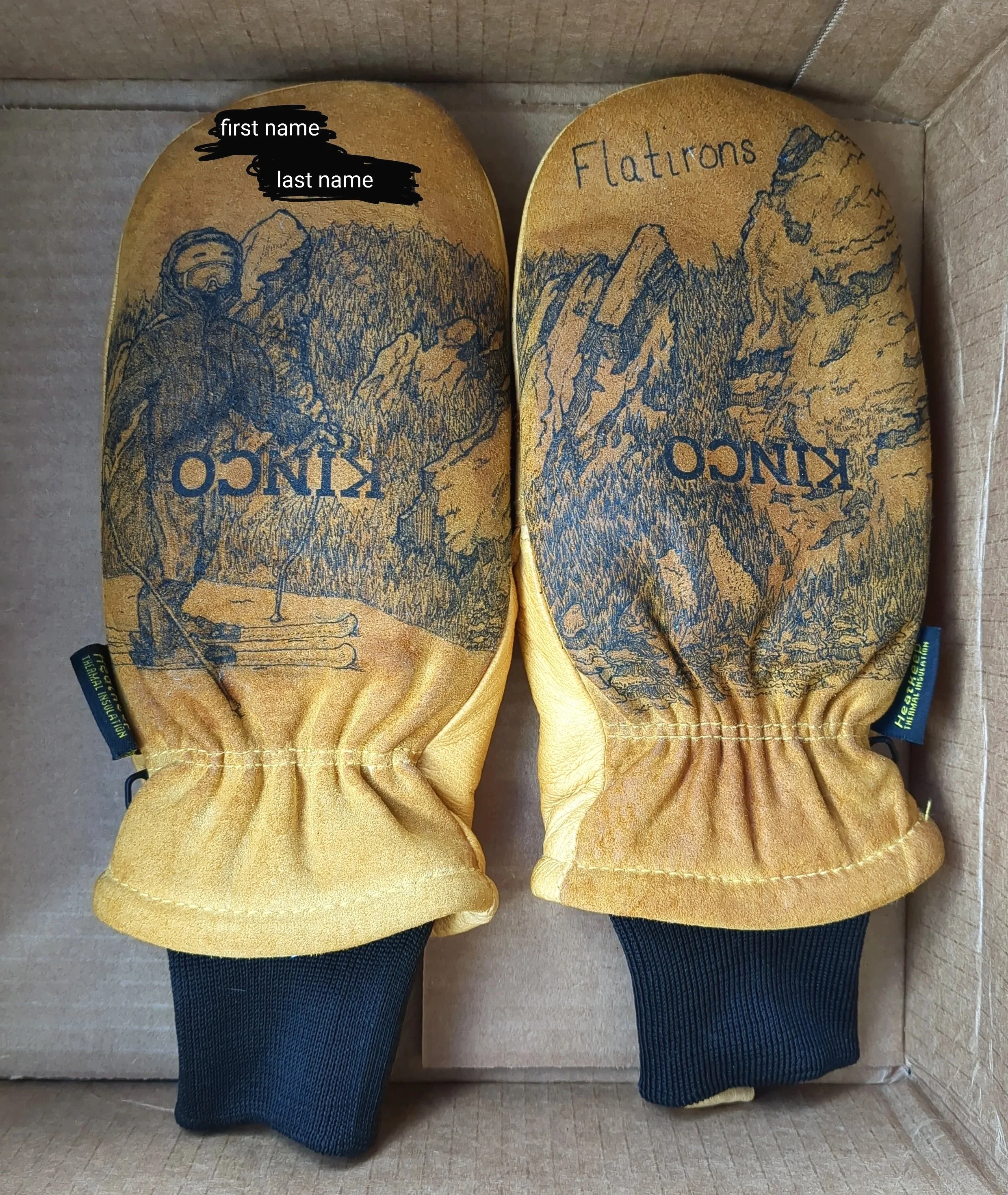 Pair of yellow and black insulated mittens with mountain and forest design, labeled 'KINCO' and 'Flatroons'.