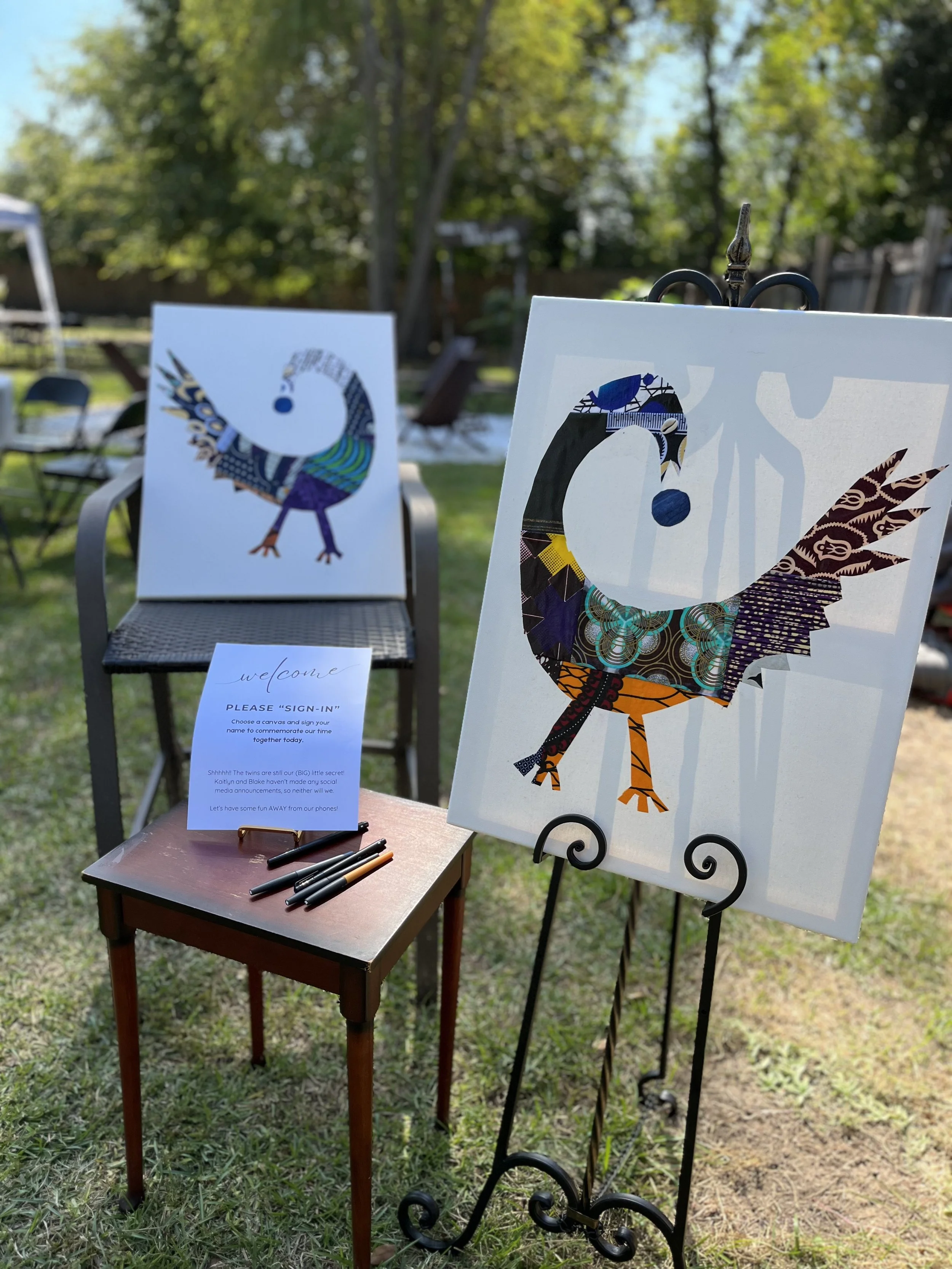 Colorful collage of a bird, made with various patterned paper, displayed on an easel outdoors in a backyard with trees and grass.
