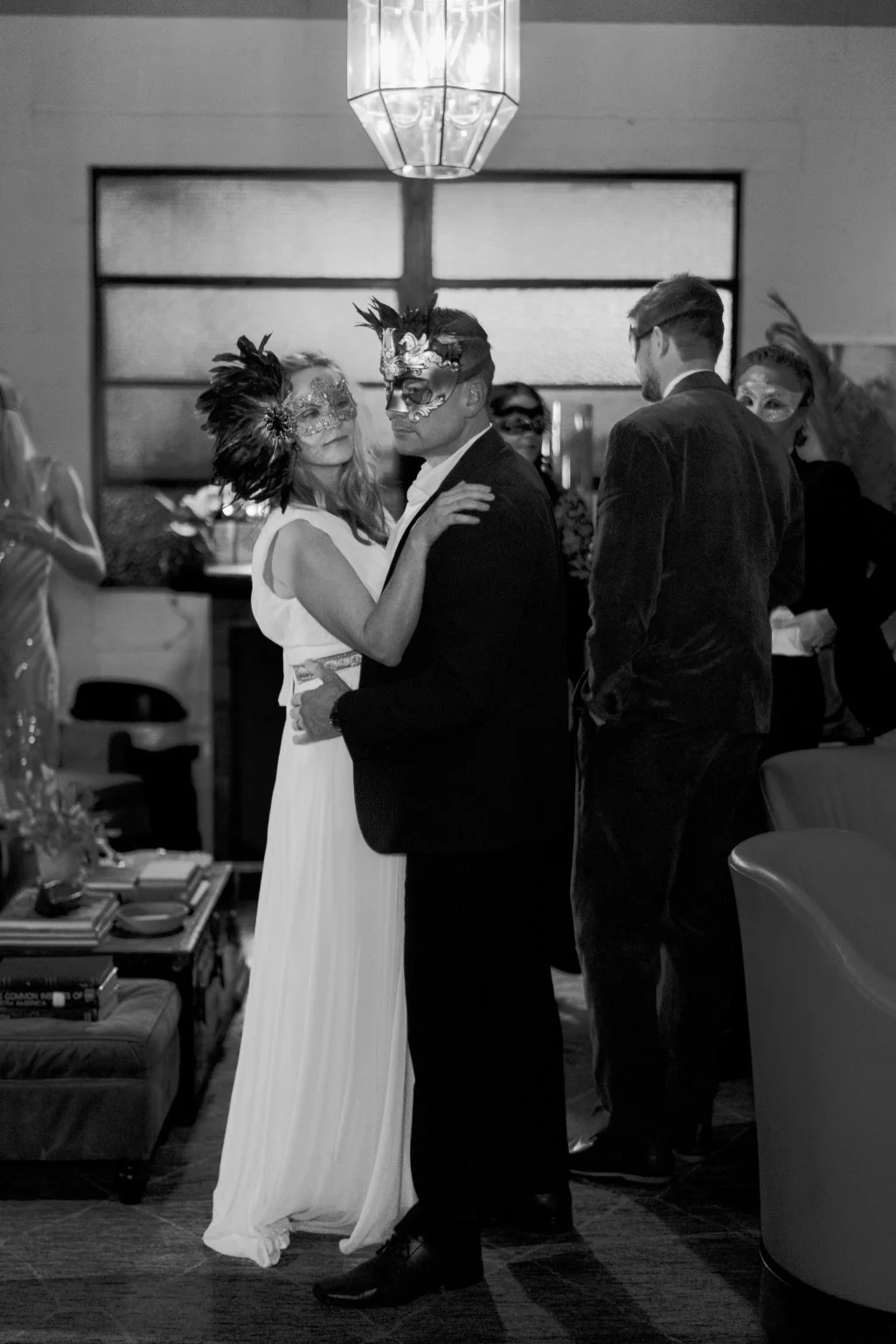 Couple wearing masks dancing at a party or celebration event