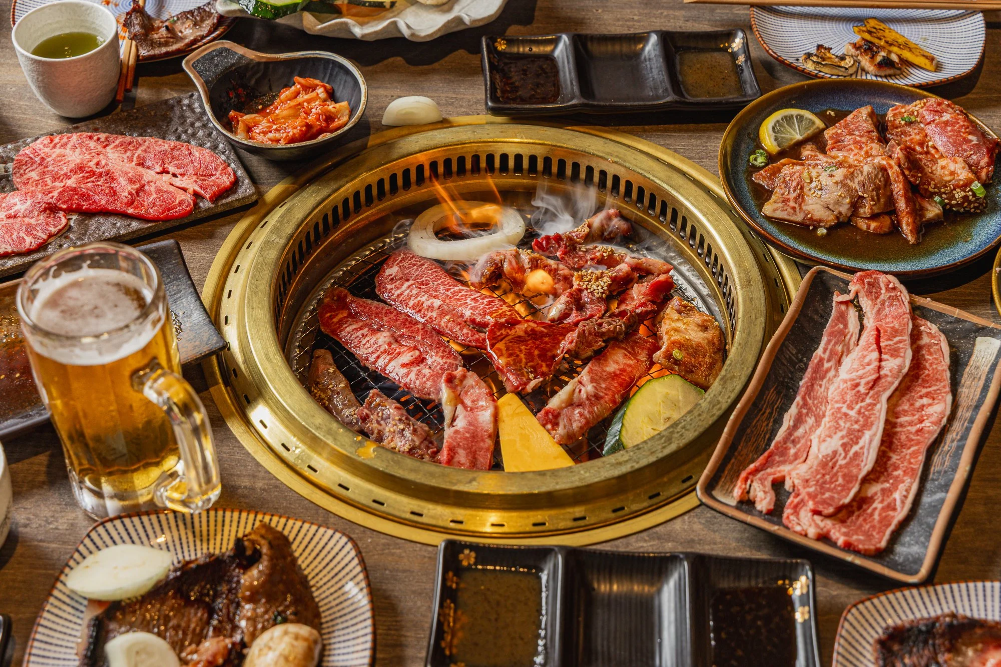 Wagyu slices grilling over flame at Japanese BBQ and hotpot in Chatswood