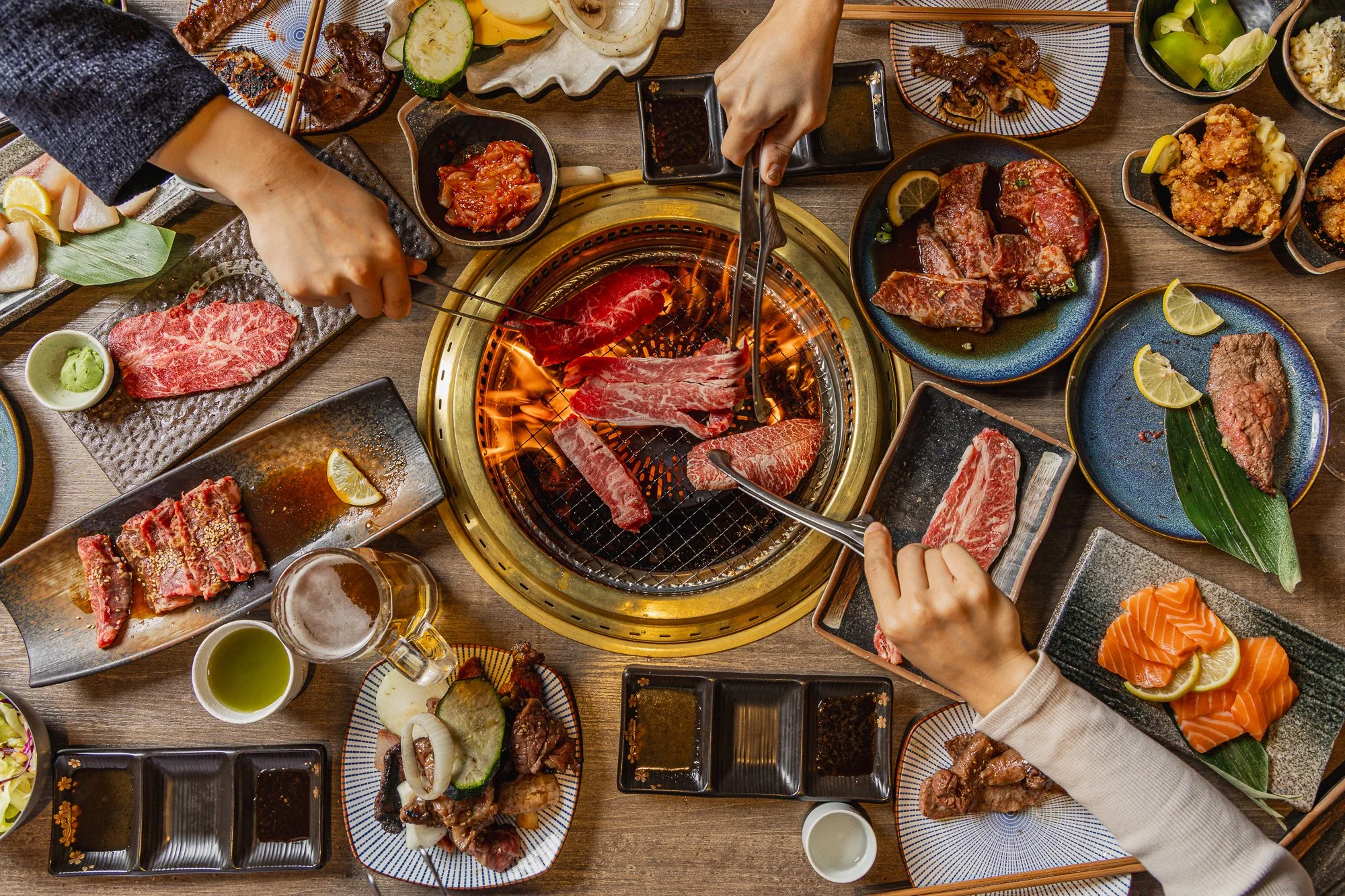 Wagyu slices grilling over flame at Japanese BBQ and hotpot in Chatswood