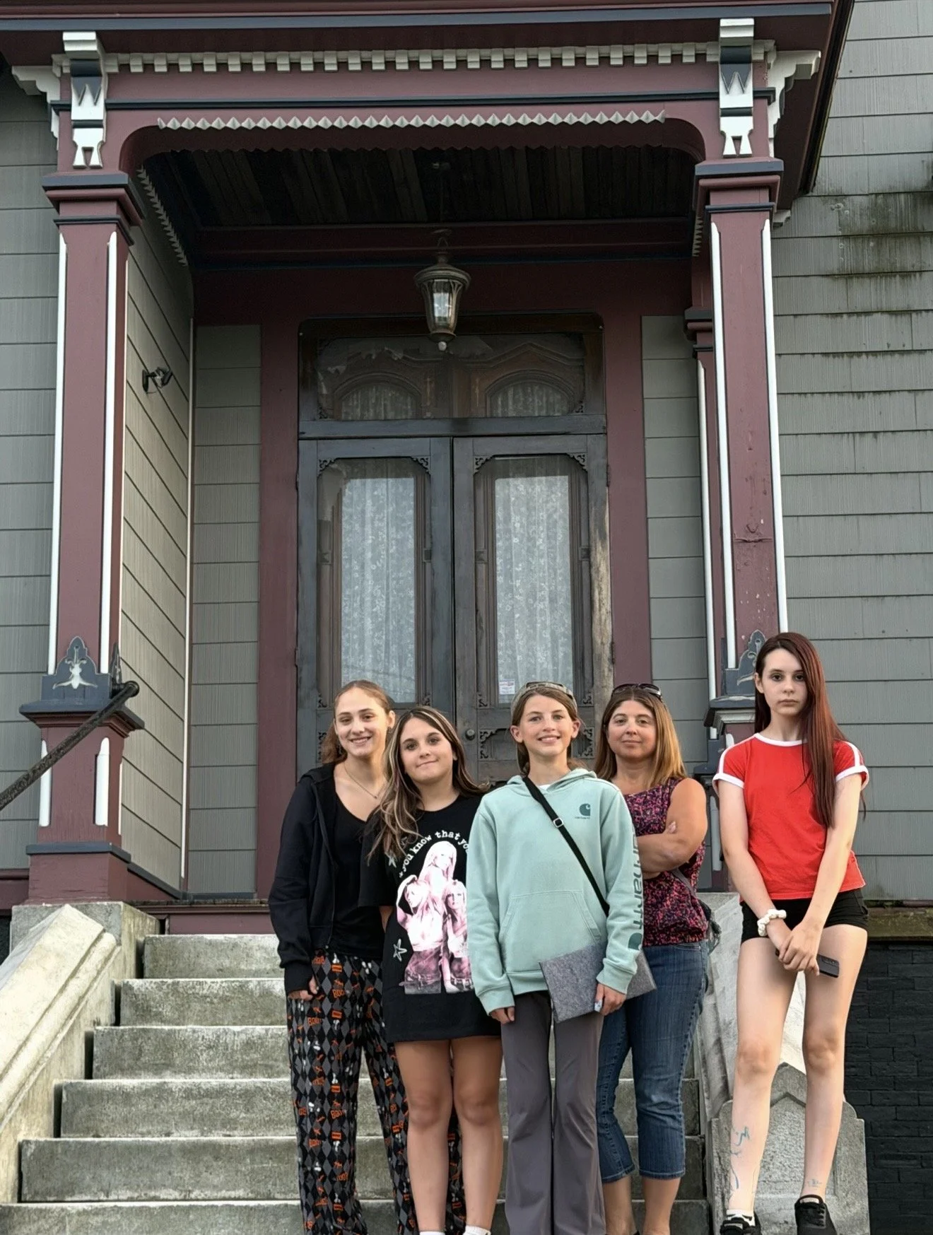 a family standing outside of the sk pierce mansion in gardner, ma