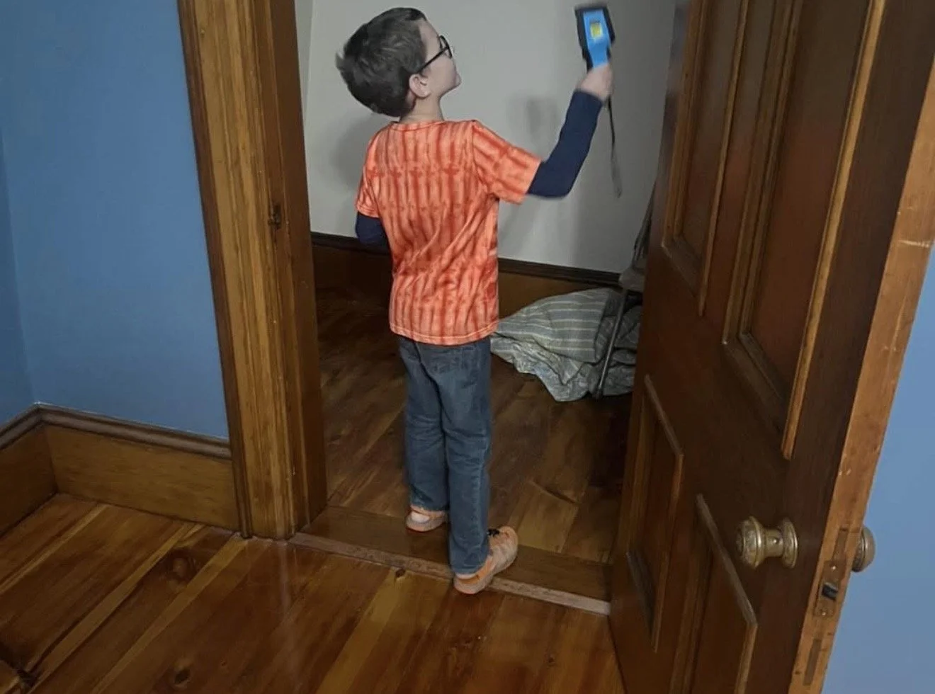 a young boy is using paranormal instruments to investigate at sk pierce mansion in gardner, ma
