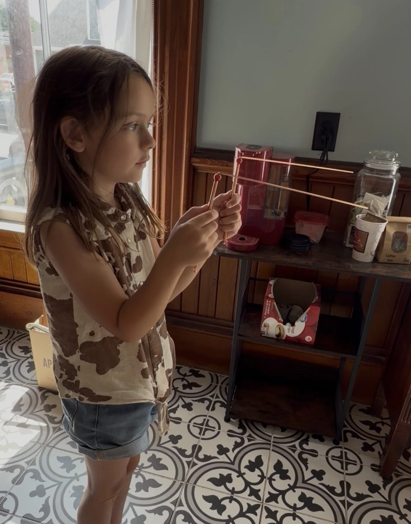 a young girl using dowsing tools at the sk pierce haunted mansion in gardner, ma