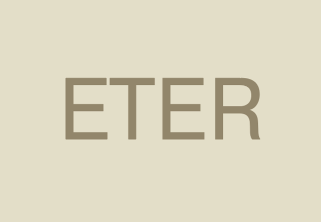 Close-up of the word 'ETER' written in large, brown uppercase letters on a light beige background.